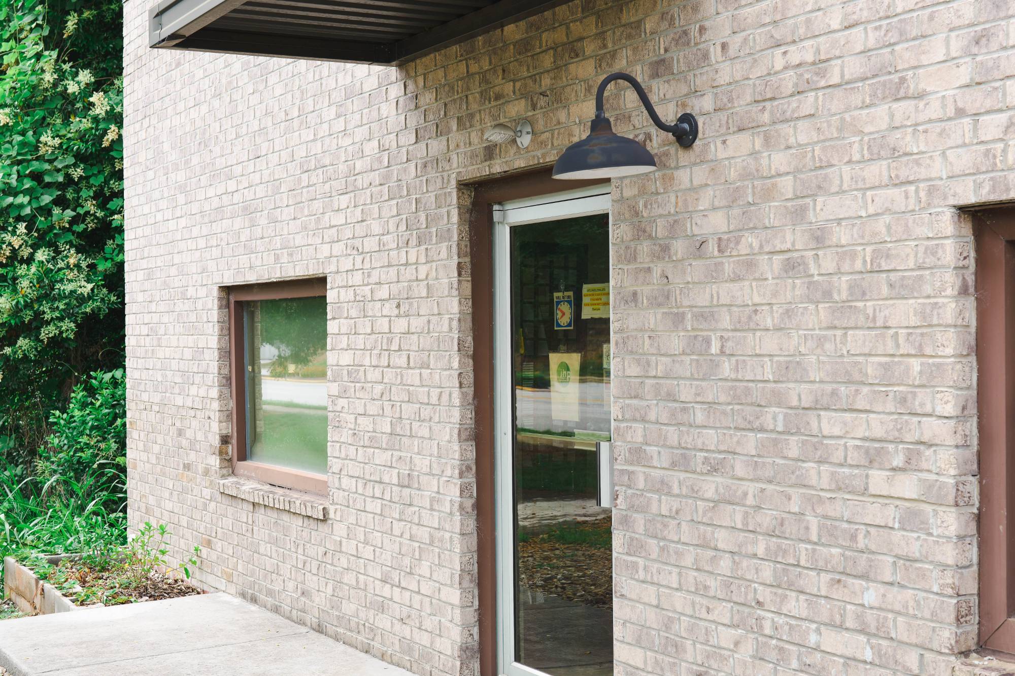Exterior of Integrative Health Partners at 319 Wade Hampton Blvd, Greenville SC — brick building with clinic entrance and surrounding greenery