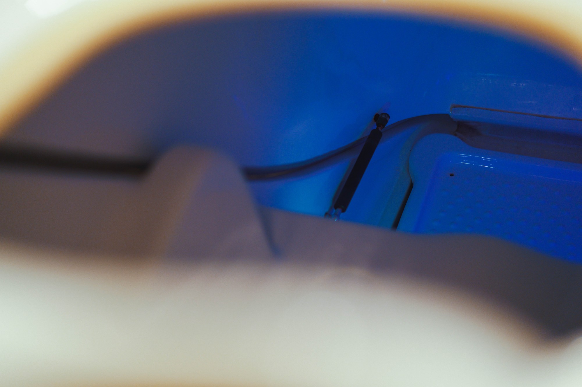 Interior of the ozone sauna cabinet with blue chromotherapy LED lighting and ozone delivery system