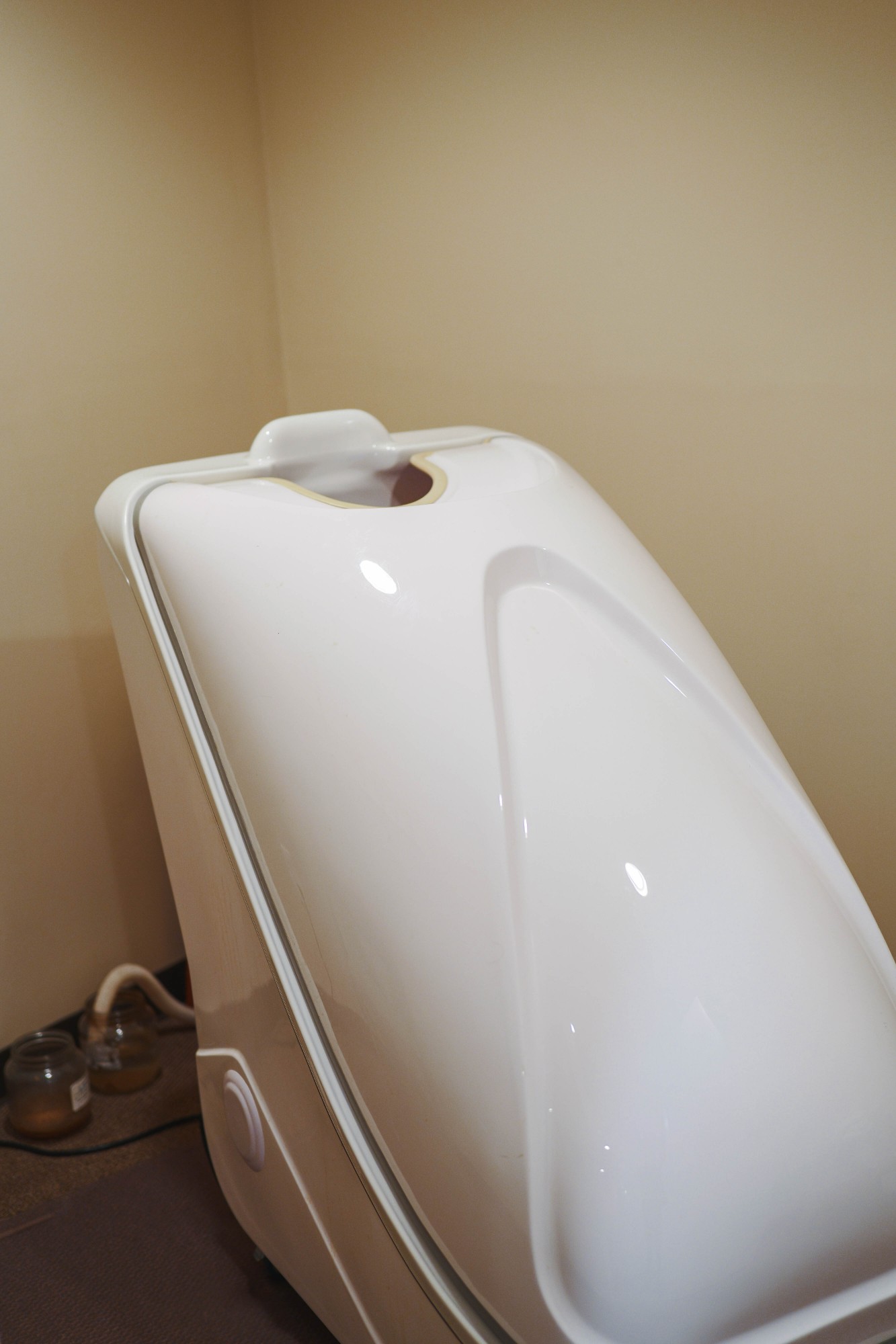 Ozone steam sauna cabinet at Integrative Health Partners, Greenville SC — patient sits inside with head outside the chamber