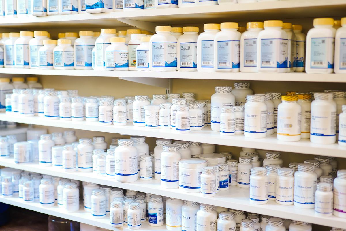 Full in-house Chinese herbal pharmacy at Integrative Health Partners Greenville SC — wall of pharmaceutical-grade herb formula bottles, bulk herbs, and specialty supplements dispensed on-site by Dr. Hendry