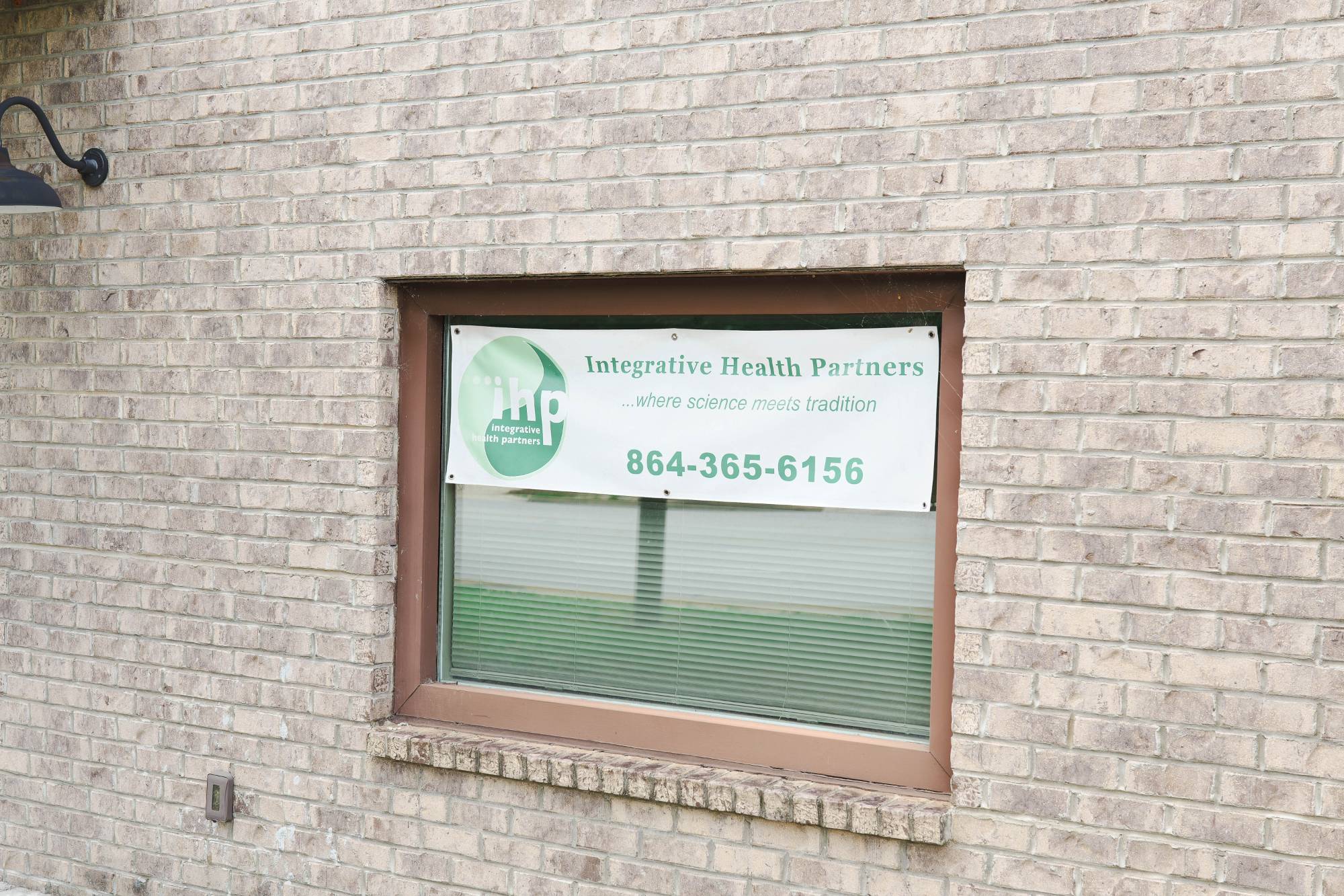 Integrative Health Partners sign at 319 Wade Hampton Blvd, Greenville SC — IHP logo with phone number 864-365-6156